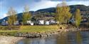 Notodden bystrand ved Nesøya Marina Gjestebrygge med Notodden Bobilcamp i bakgrunn. Foto